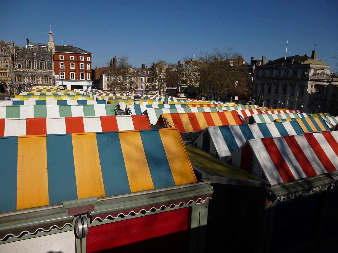 The striped canopies of Norwich Market seen from above